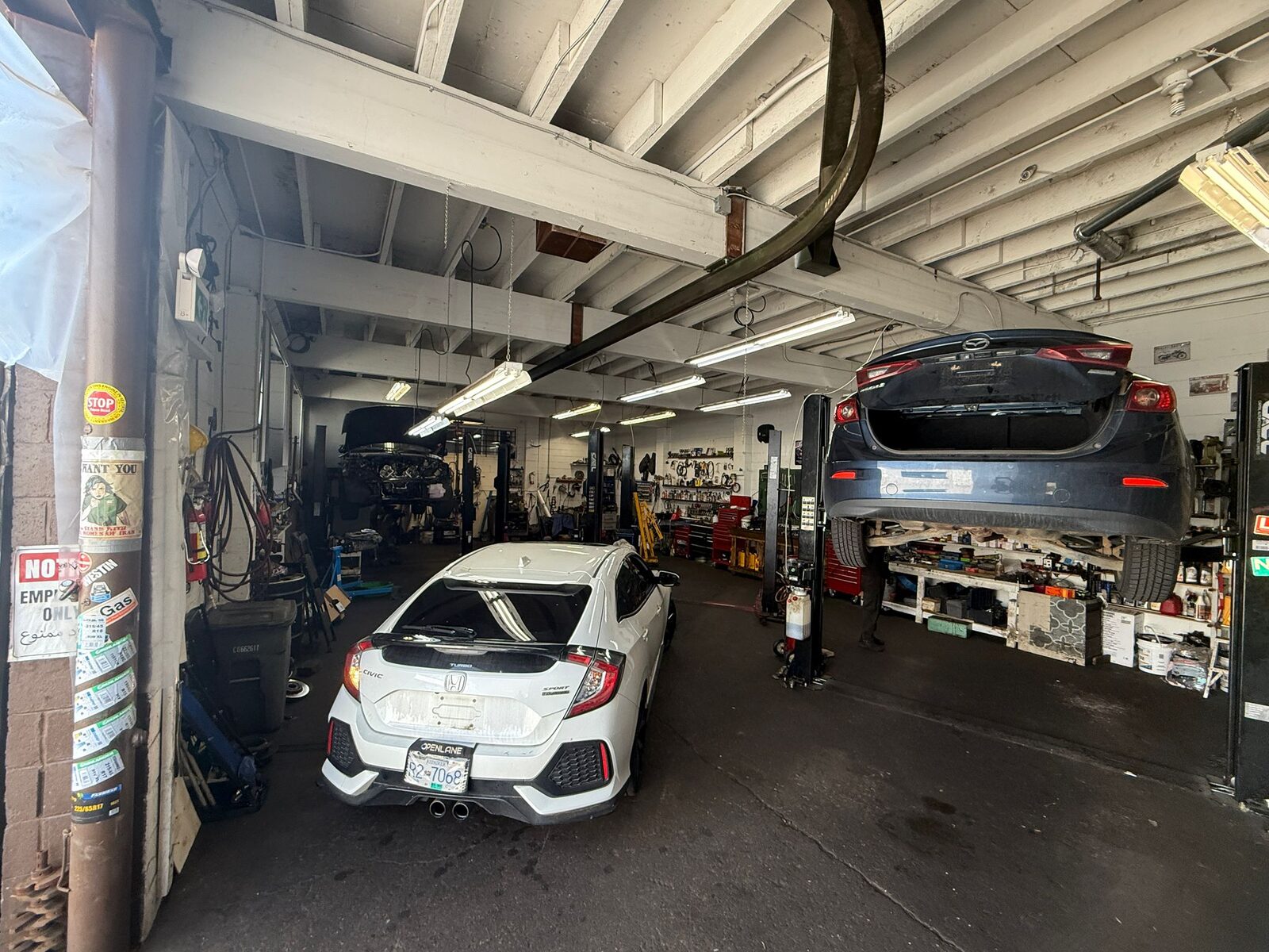 Vehicles being serviced inside the shop