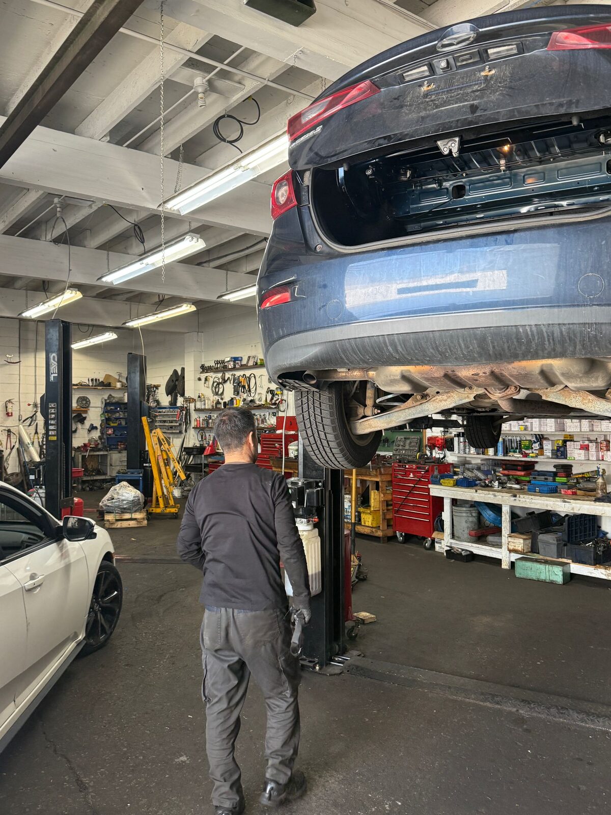 Hamid Auto mechanic working under a vehicle
