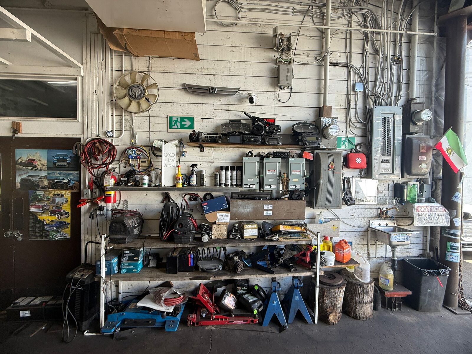 Organized tool and parts wall at Hamid Auto, with shop equipment